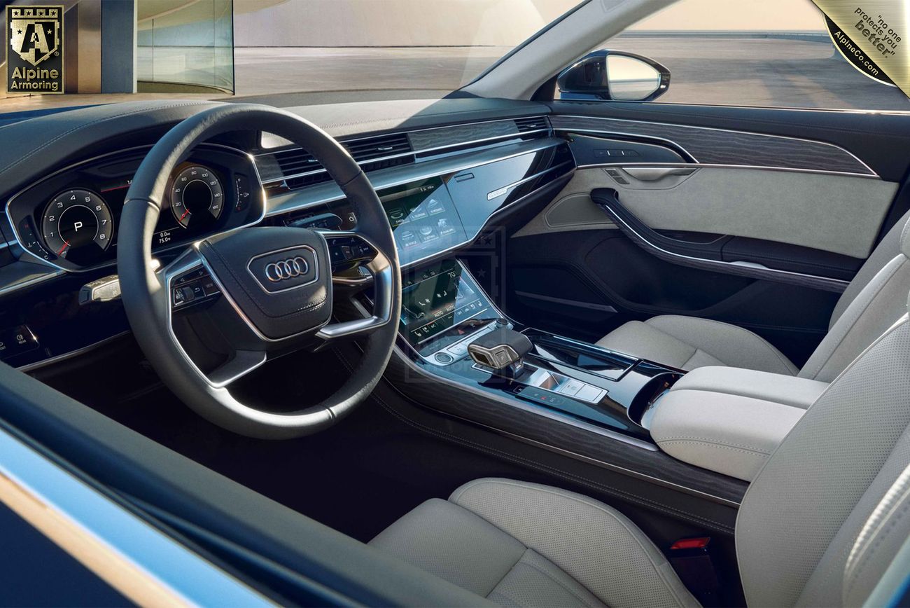 Interior view of a Audi A8, featuring a sophisticated dashboard with digital displays, a multi-function steering wheel, and luxurious leather seating.