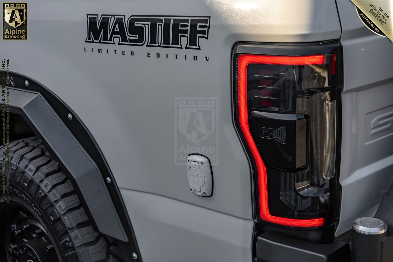 Close-up of the rear section of a white "Mastiff Limited Edition," showing the taillight and part of a large tire. 