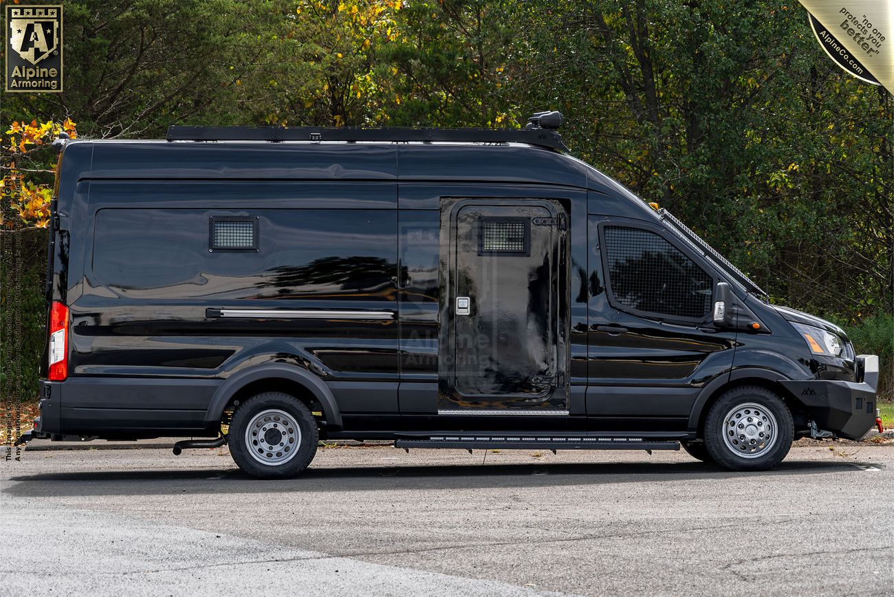 Right side view of a black armored SWAT van, known as the Armored Pointer from Alpine Armoring, featuring reinforced windows, tactical lighting, and emergency lights.
