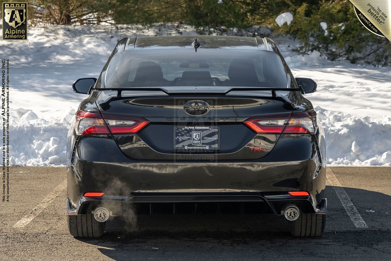 Rear view of a Toyota Camry TRD sedan in a snowy environment.