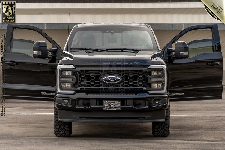 Black Ford F-350 Super Duty pickup truck with front doors open, showing bold mesh grille and stacked LED headlights in parking structure.
