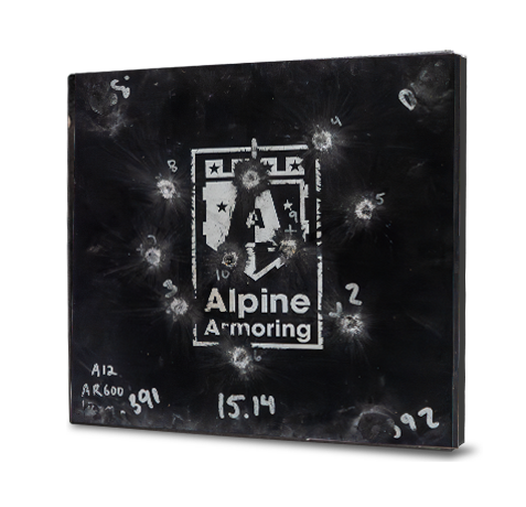 A black armored steel panel labeled "Alpine Armoring" with multiple bullet impact marks and test data written on it.