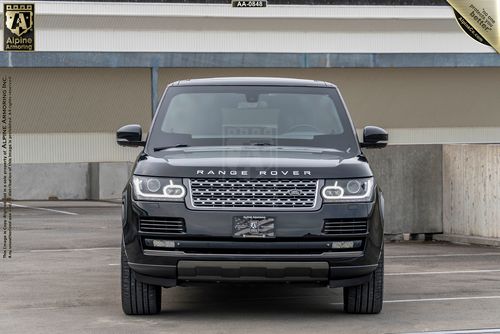 Front view of a black Range Rover Autobiography parked in a parking garage with a custom license plate.